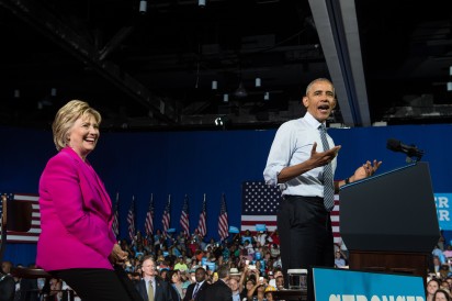 US President Barack Obama speaks at a campaign event for Democratic presidential candidate Hillary Clinton (L) in Charlotte, North Carolina, on July 5, 2016. US President Barack Obama threw his full weight behind Hillary Clinton's bid to succeed him, extolling the experience and fighting spirit of his former secretary of state at their first joint campaign appearance.  "I'm here today because I believe in Hillary Clinton," Obama told the rally in Charlotte, North Carolina. "There has never been any man or woman more qualified for this office."  / AFP PHOTO / NICHOLAS KAMM
