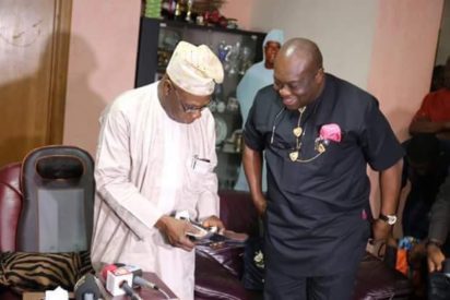 Obasanjo takes delivery of Made-in-Aba shoes. Pledged to step up the promotion of Made-in-Nigeria products.
