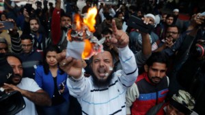 Demonstrators burn copies of the Citizenship Amendment Bill, December 10, 2019.