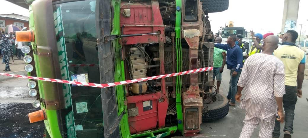 Two dead, as container-laden truck falls on bus in Lagos